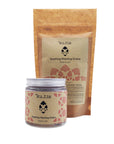 Natural soothing washing grains in powder form in a glass jar with an aluminium screw top silver lid. Next to a kraft paper refill pouch.