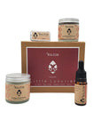 Kraft gift box with purple label containing indulgent body butter, naked lip balm, radiance serum and soothing washing grains. Made in Wales by Kutis Skincare.